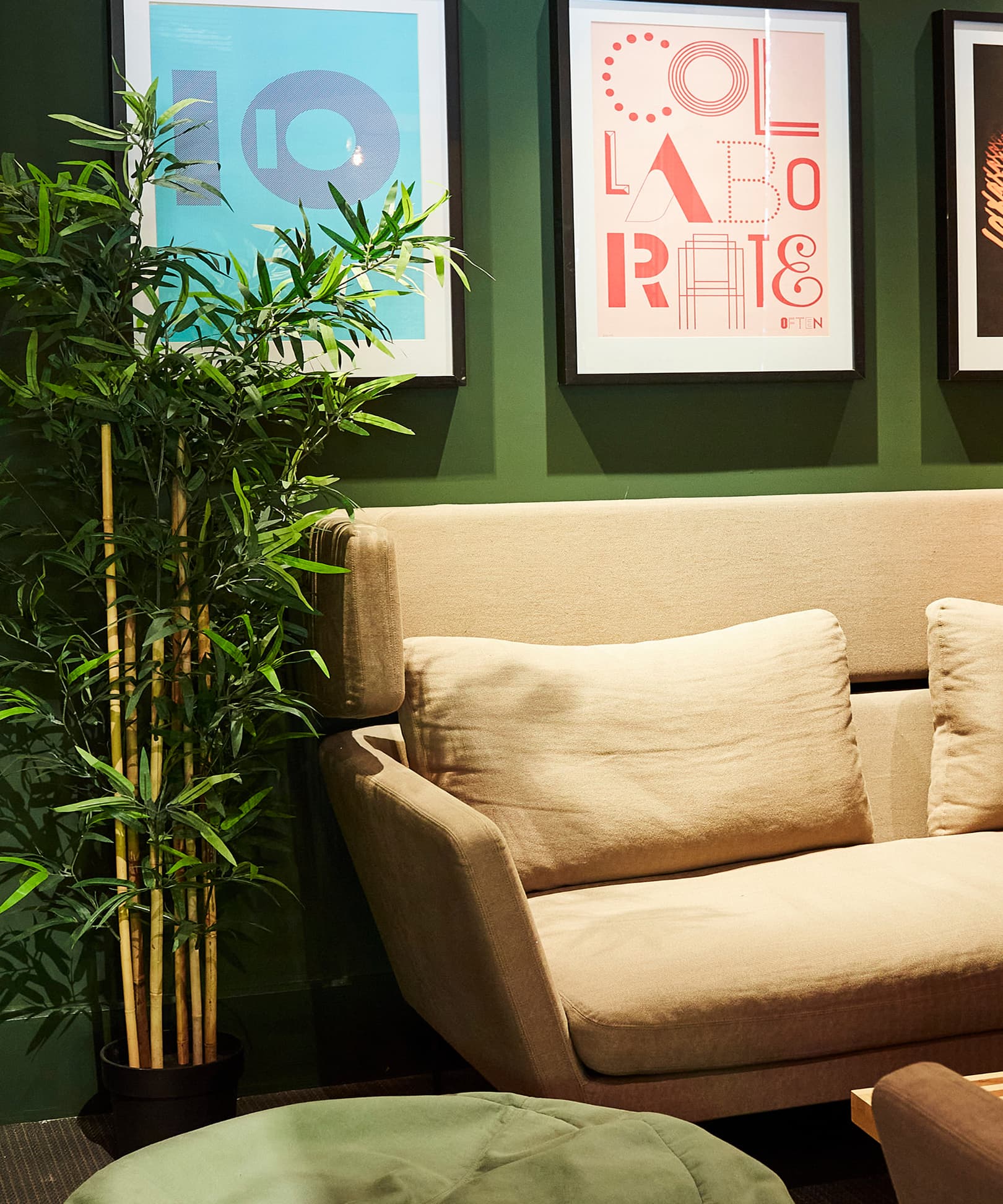 Sofa against a dark green wall
